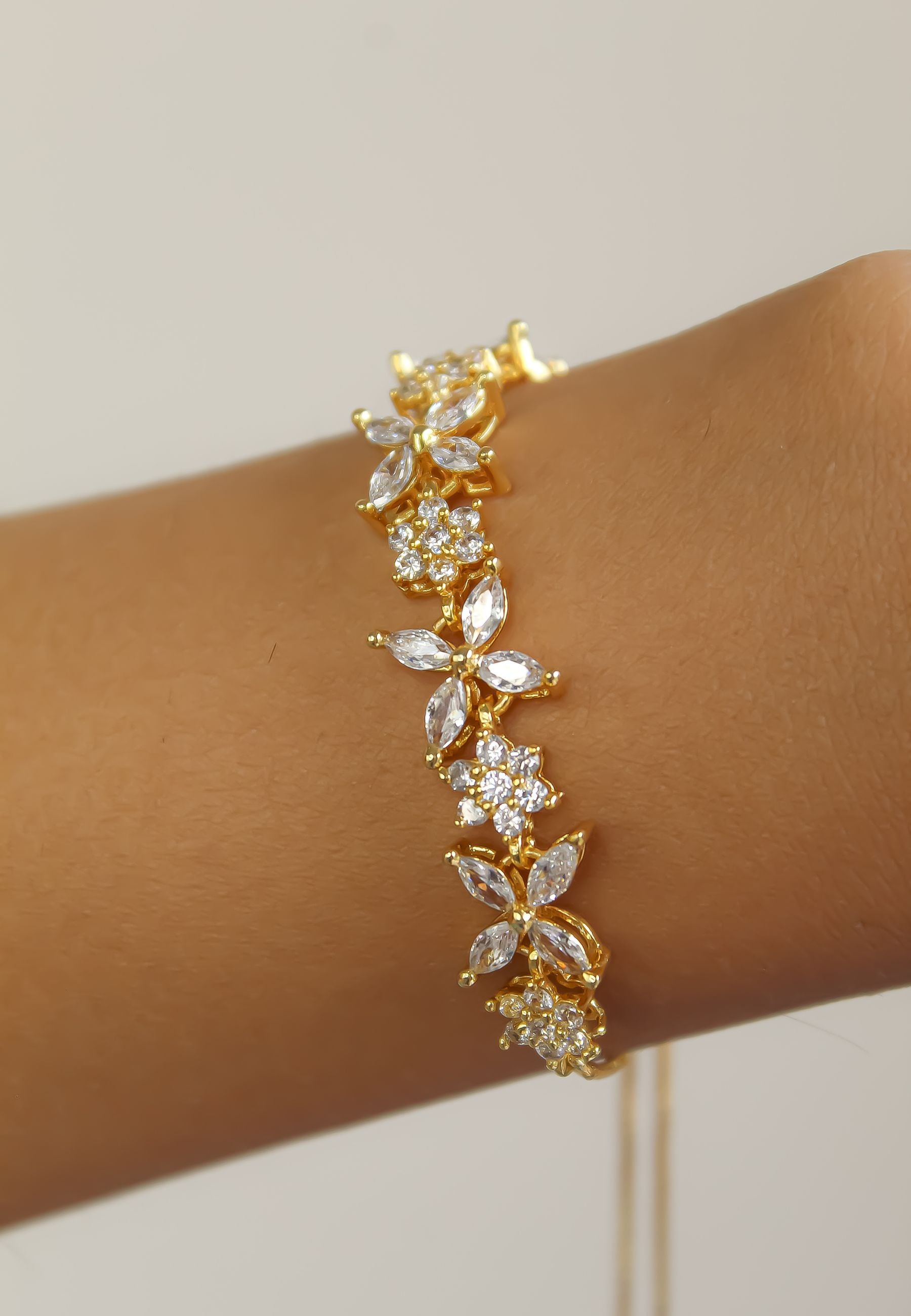 Elegant Elsa Bracelet featuring 18k gold or silver plating with authentic zircons, adjustable design for a perfect fit.