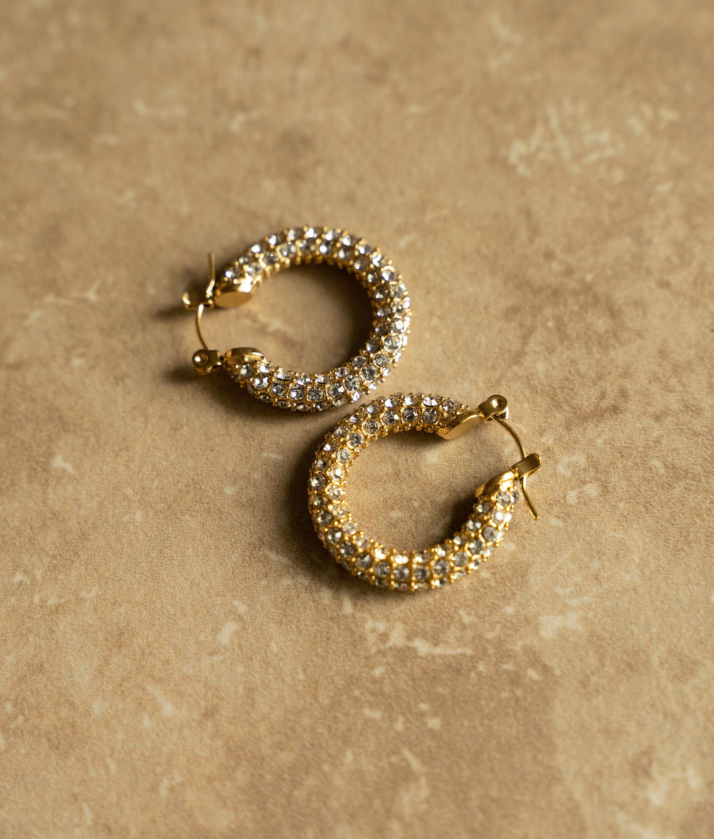 ELSA Hoops featuring a classic donut shape with brilliant cut stones, crafted in 18k gold plated stainless steel.