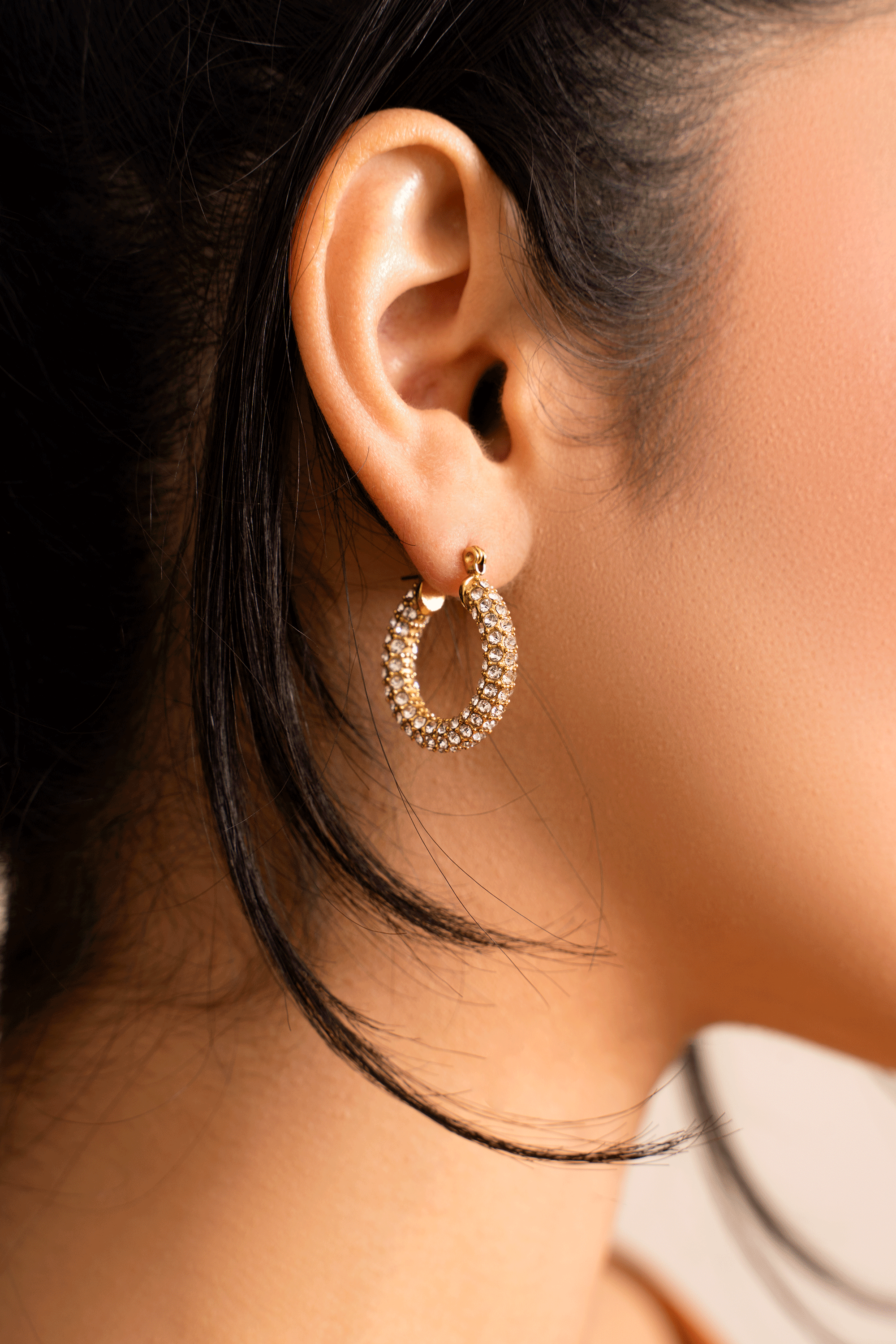 ELSA Hoops featuring a classic donut shape with brilliant cut stones, crafted in 18k gold plated stainless steel.