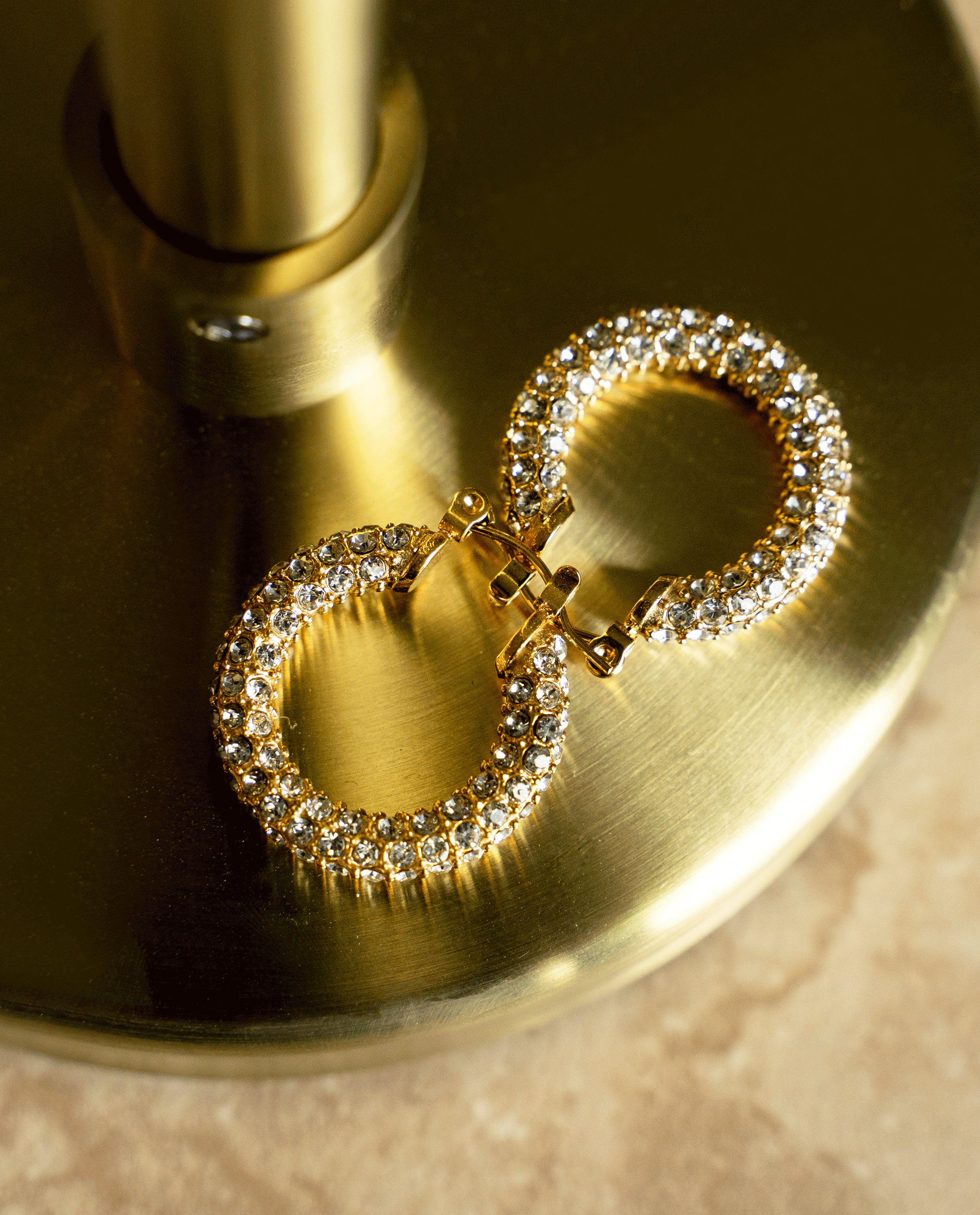 ELSA Hoops featuring a classic donut shape with brilliant cut stones, crafted in 18k gold plated stainless steel.