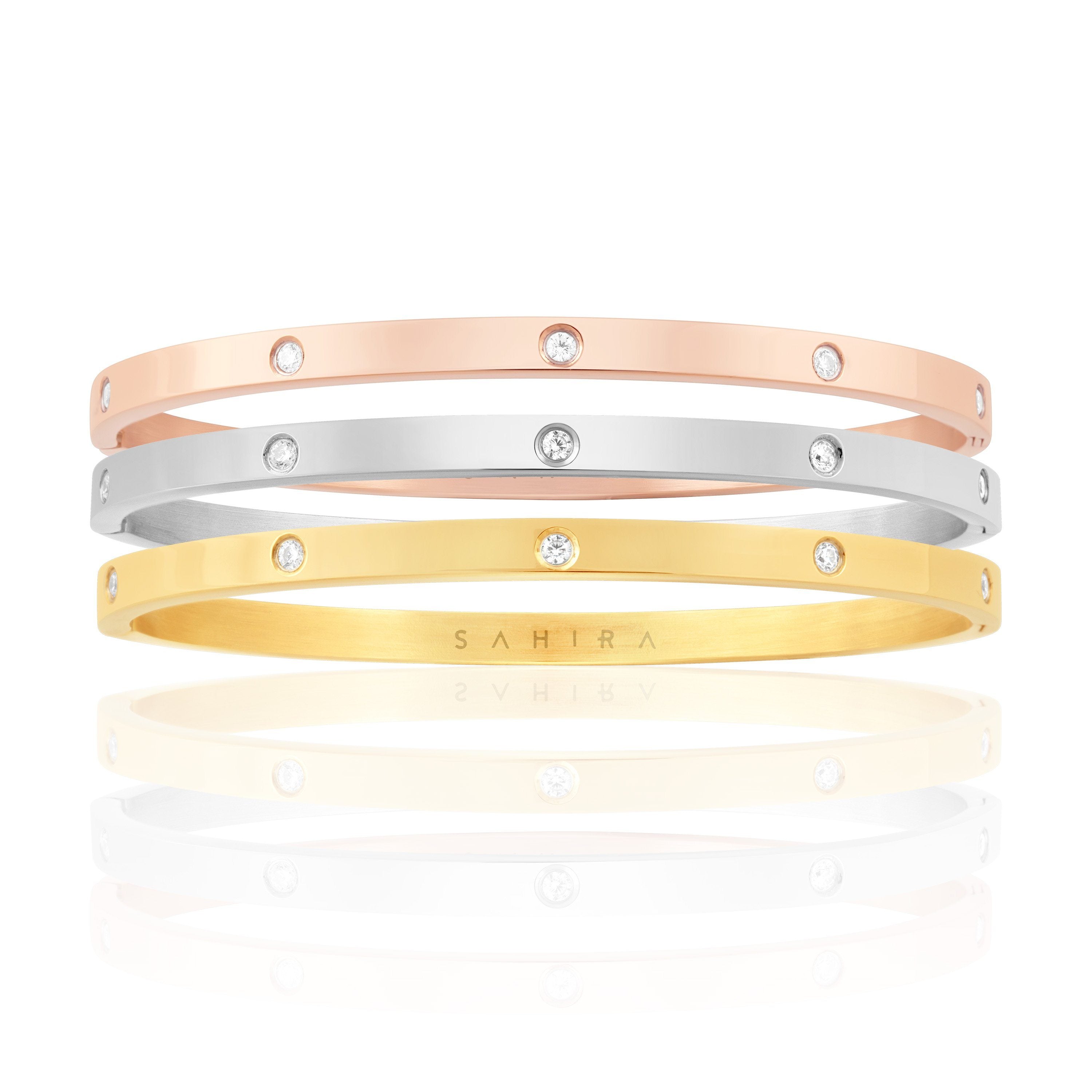 Elsie Trio Stack featuring gold, rose gold, and silver bracelets elegantly stacked together.