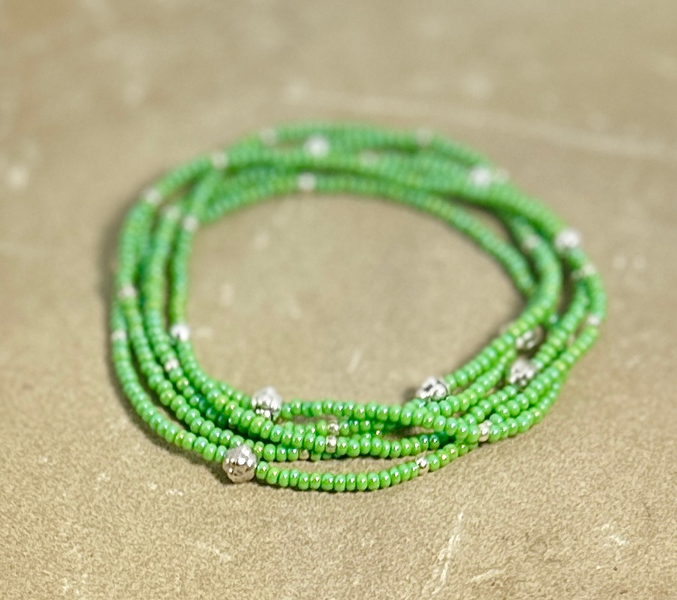 Emerald green beaded wrap bracelet with silver and gold accents, showcasing vibrant Czech glass seed beads and a bohemian style.