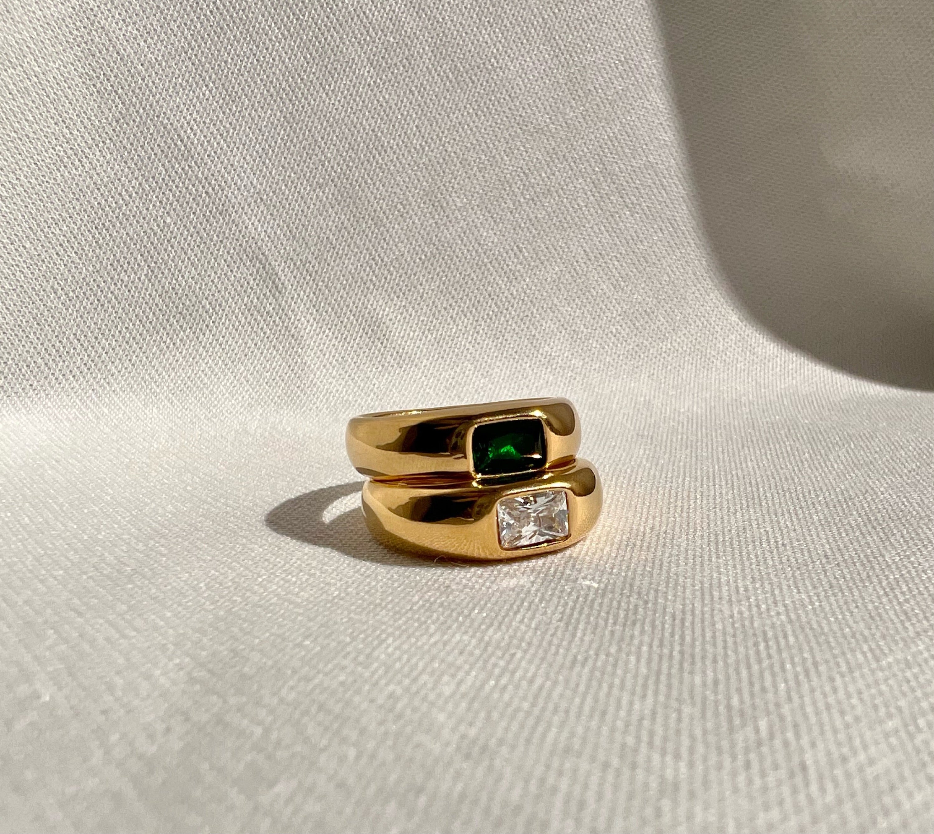 Emerald Statement Ring featuring green cubic zirconia set in stainless steel with 18k gold plating, showcasing a luxurious and elegant design.