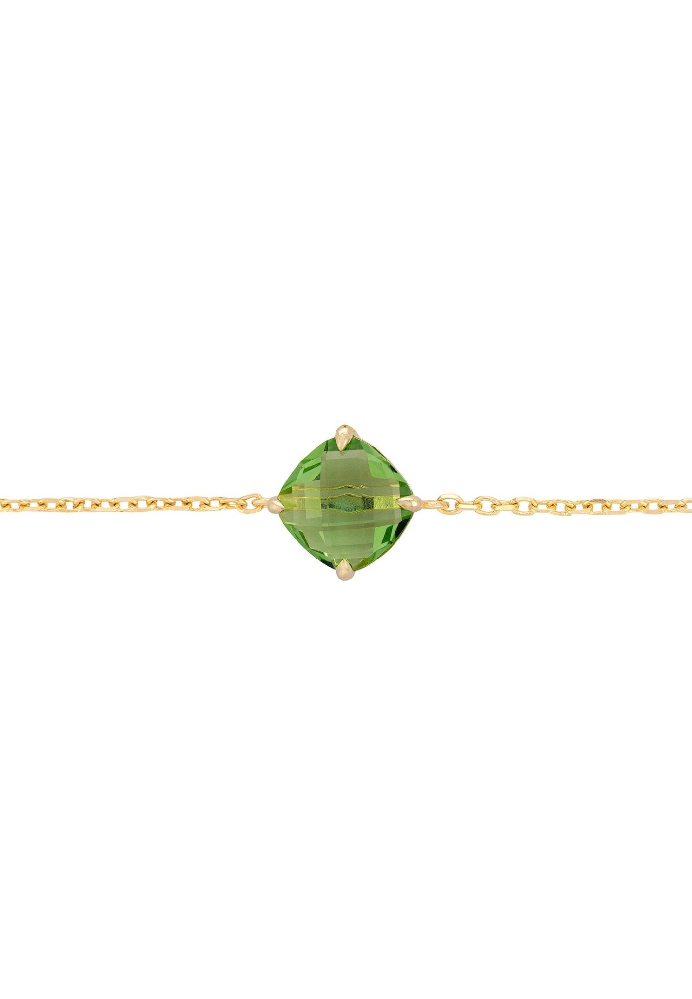 Empress Peridot Gemstone Bracelet in gold with a vibrant green peridot gemstone, elegantly displayed on a soft surface.