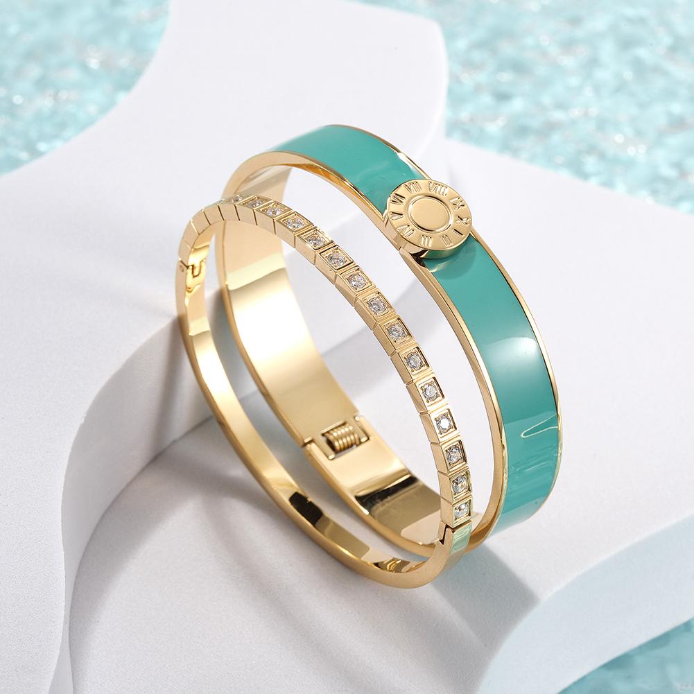 A stylish Enamel Pavé Bangle Set featuring CZ stones and Roman numerals, elegantly displayed in a gift box.