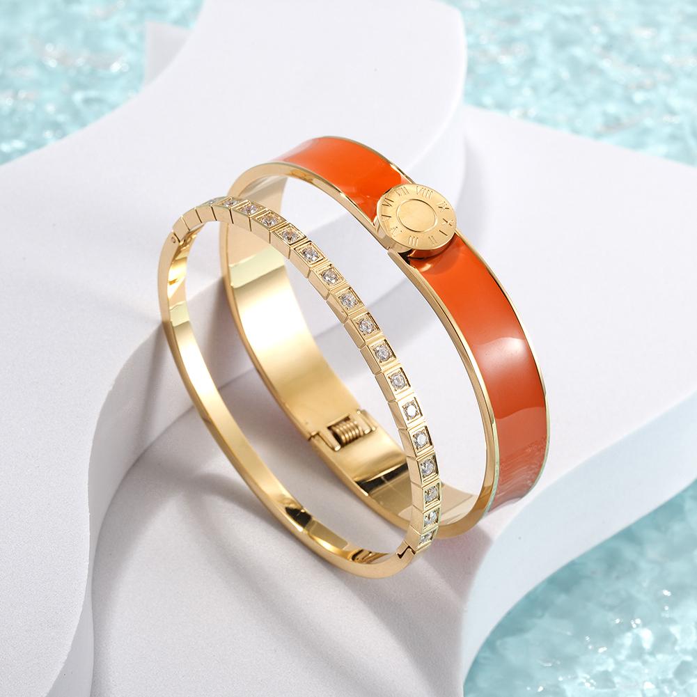 A stylish Enamel Pavé Bangle Set featuring CZ stones and Roman numerals, elegantly displayed in a gift box.