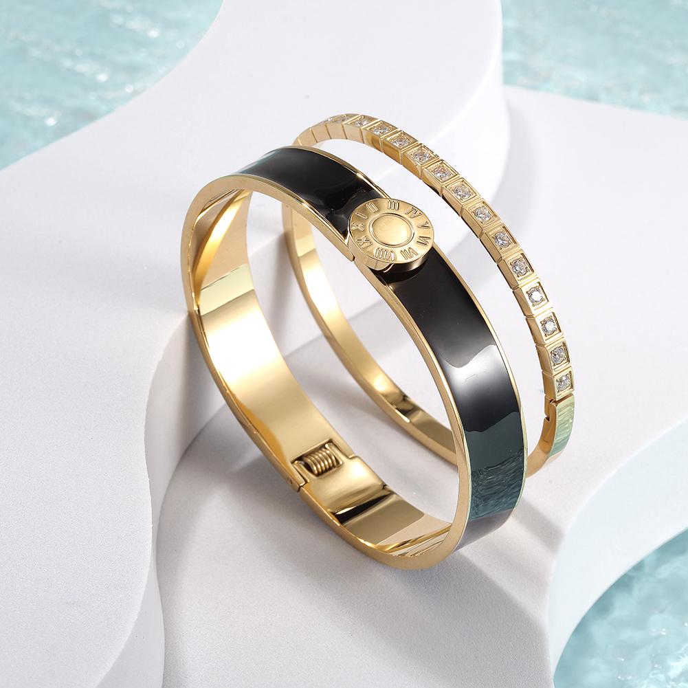 A stylish Enamel Pavé Bangle Set featuring CZ stones and Roman numerals, elegantly displayed in a gift box.