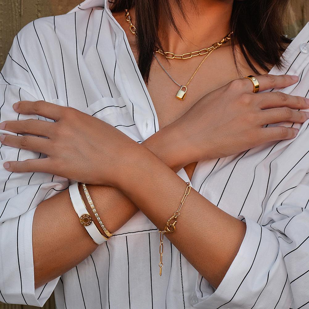 A stylish Enamel Pavé Bangle Set featuring CZ stones and Roman numerals, elegantly displayed in a gift box.