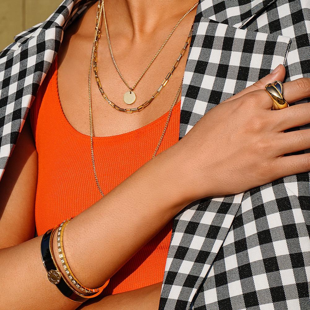 A stylish Enamel Pavé Bangle Set featuring CZ stones and Roman numerals, elegantly displayed in a gift box.