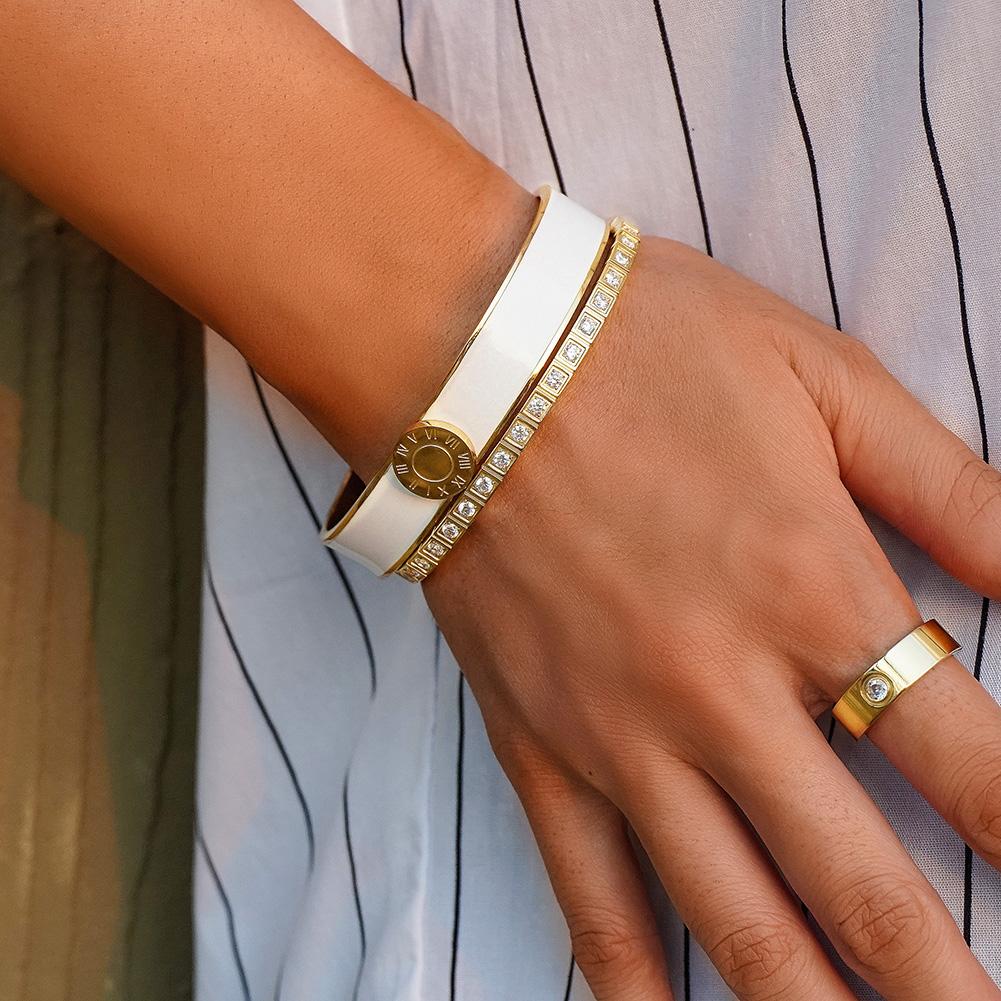 A stylish Enamel Pavé Bangle Set featuring CZ stones and Roman numerals, elegantly displayed in a gift box.