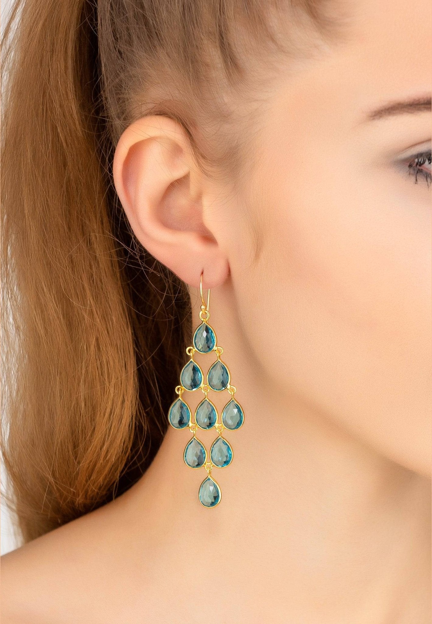 Erviola Gemstone Cascade Earrings featuring Blue Topaz, designed with teardrop gemstones and a polished gold finish.