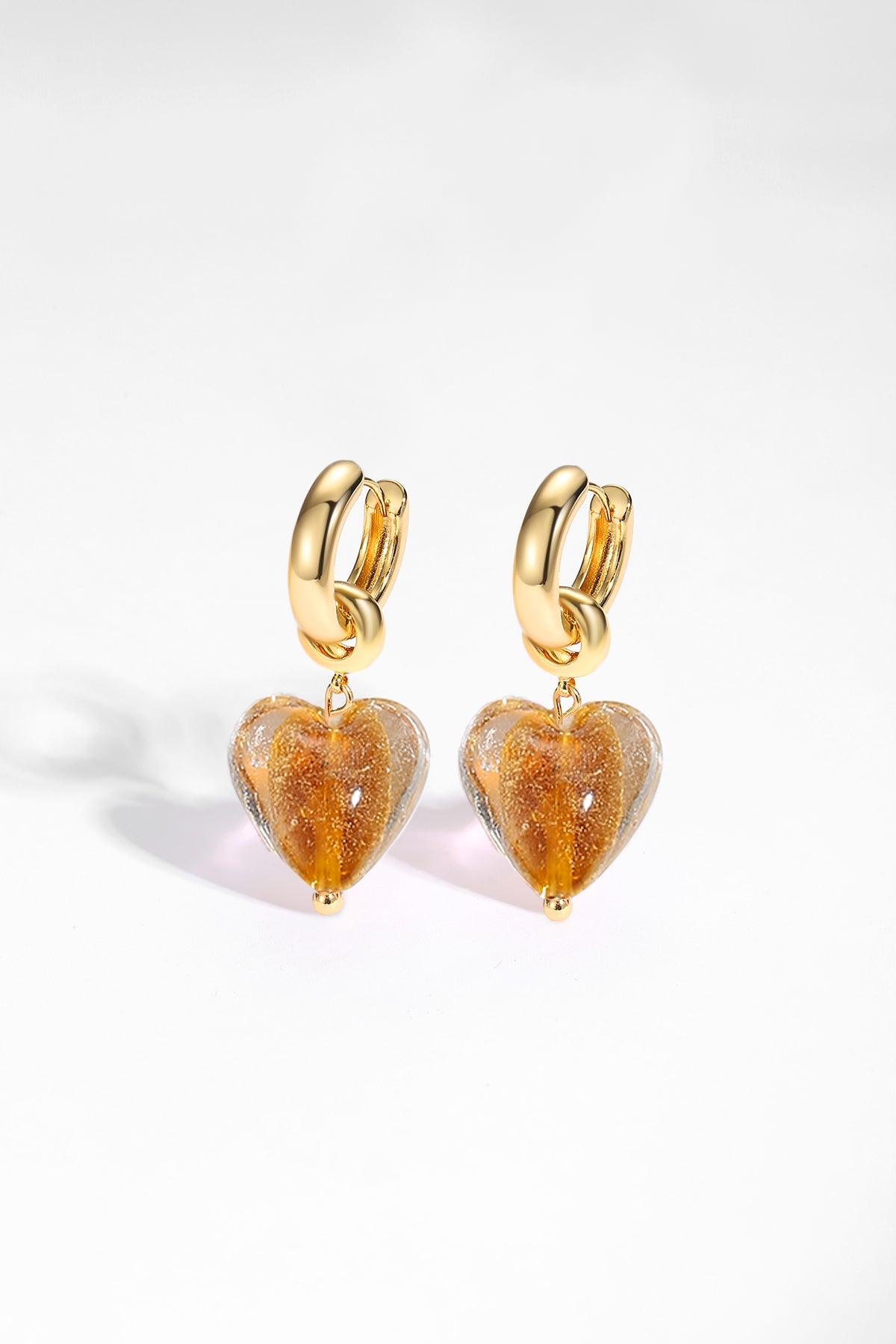 Esmée Amber Glaze Heart Dangle Earrings featuring colorful glass hearts and 18k gold plated hoops, showcasing unique handmade craftsmanship.