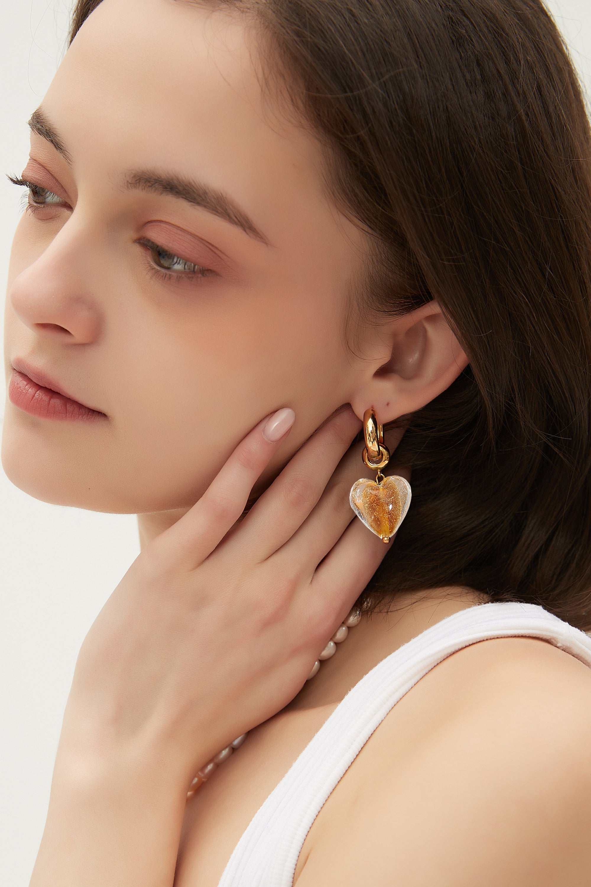 Esmée Amber Glaze Heart Dangle Earrings featuring colorful glass hearts and 18k gold plated hoops, showcasing unique handmade craftsmanship.