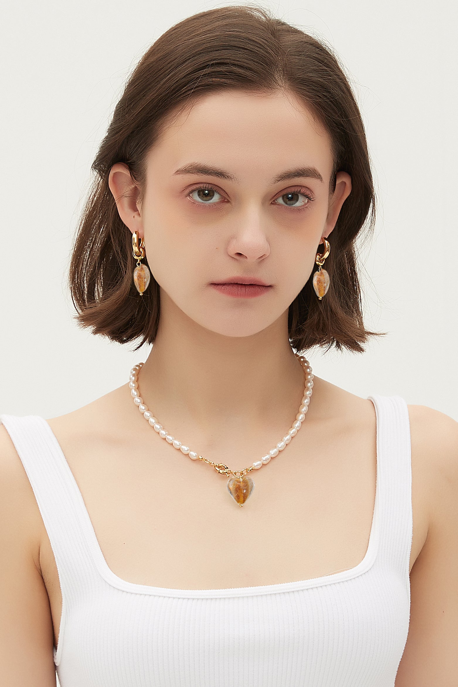 Esmée Amber Glaze Heart Pendant Pearl Necklace featuring baroque pearls and colorful glass pendant, elegantly displayed on a soft background.