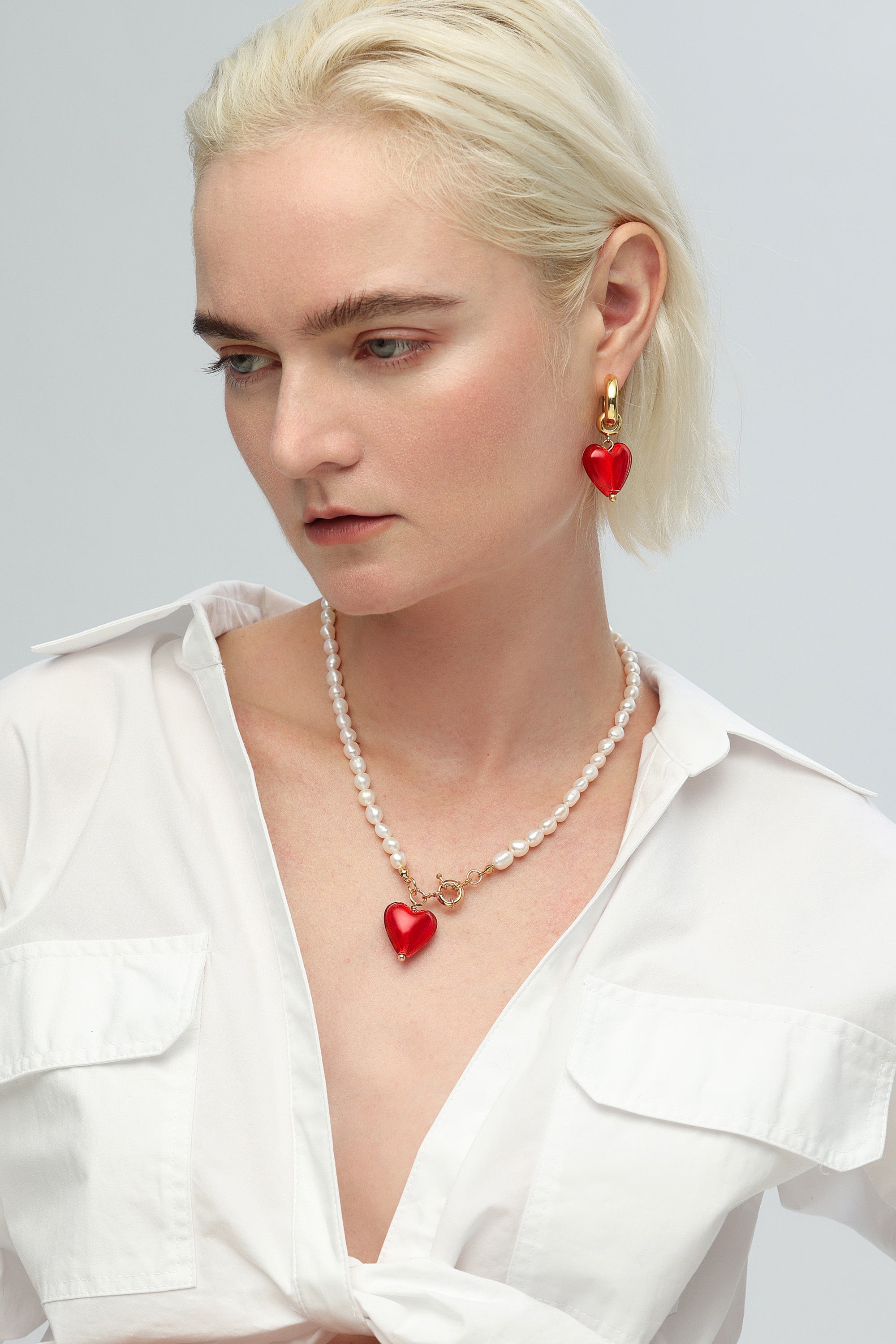 Esmée Red Glaze Heart Pendant Pearl Necklace featuring lustrous baroque pearls and a colorful glass heart pendant, elegantly displayed.