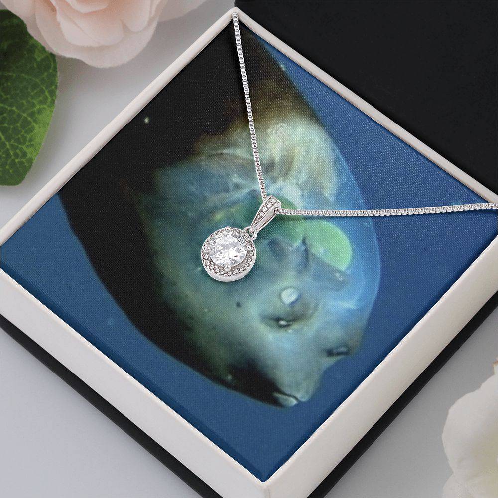 Eternal Hope Necklace featuring a cushion cut cubic zirconia surrounded by accent CZ crystals, elegantly displayed in a soft touch gift box.