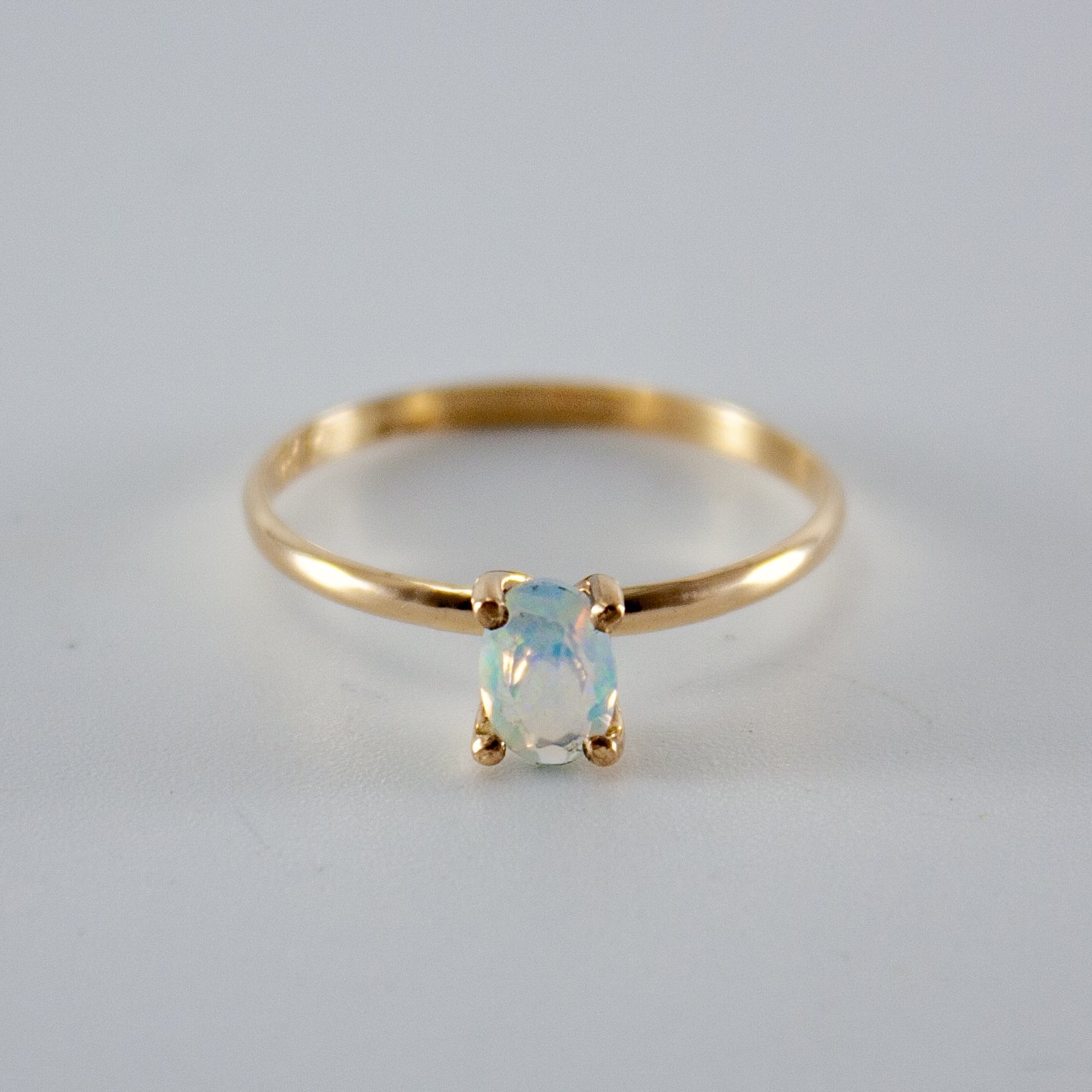 Ethiopian Opal Oval Solitaire Ring in 14k Gold Filled setting, showcasing vibrant colors and brilliant cut.