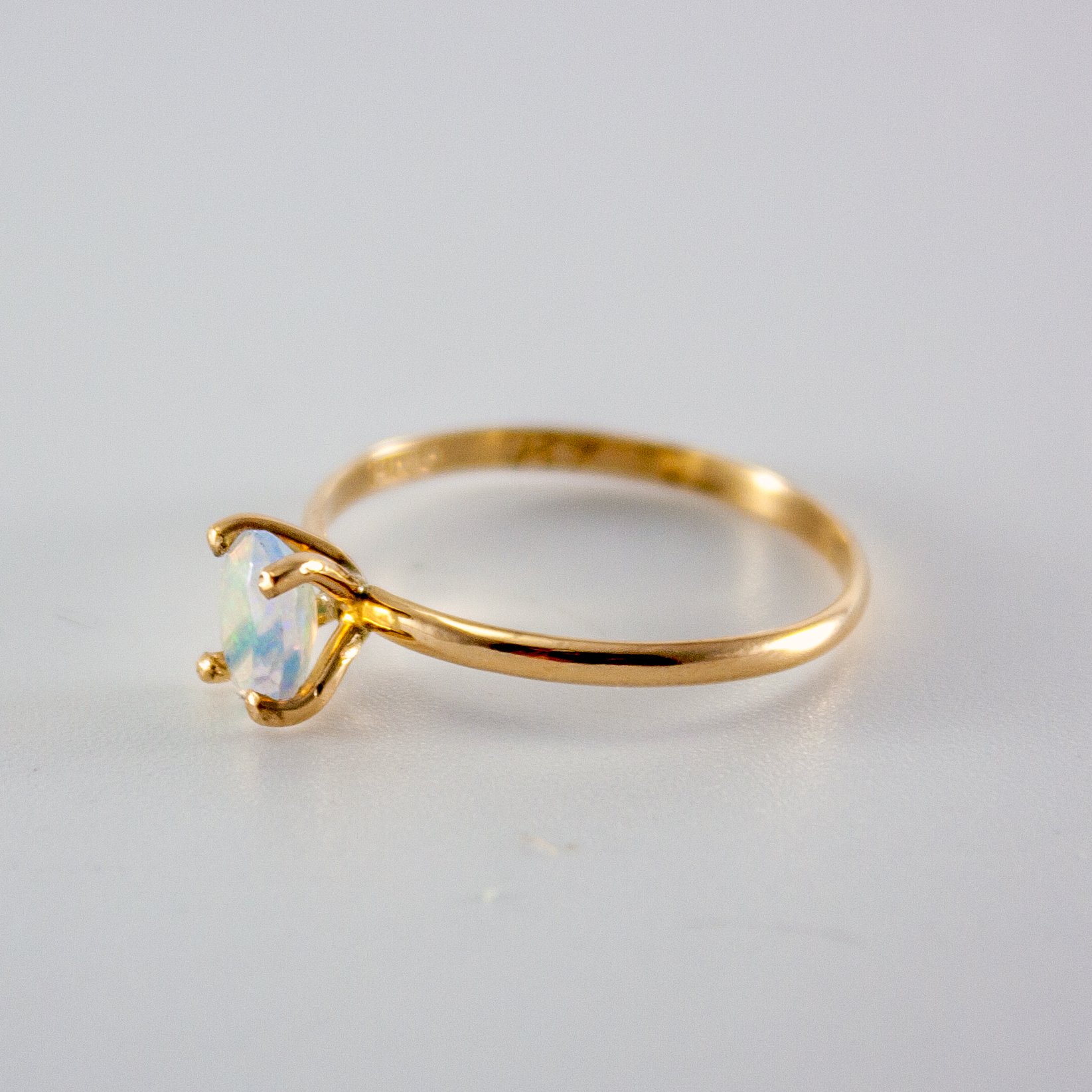 Ethiopian Opal Oval Solitaire Ring in 14k Gold Filled setting, showcasing vibrant colors and brilliant cut.