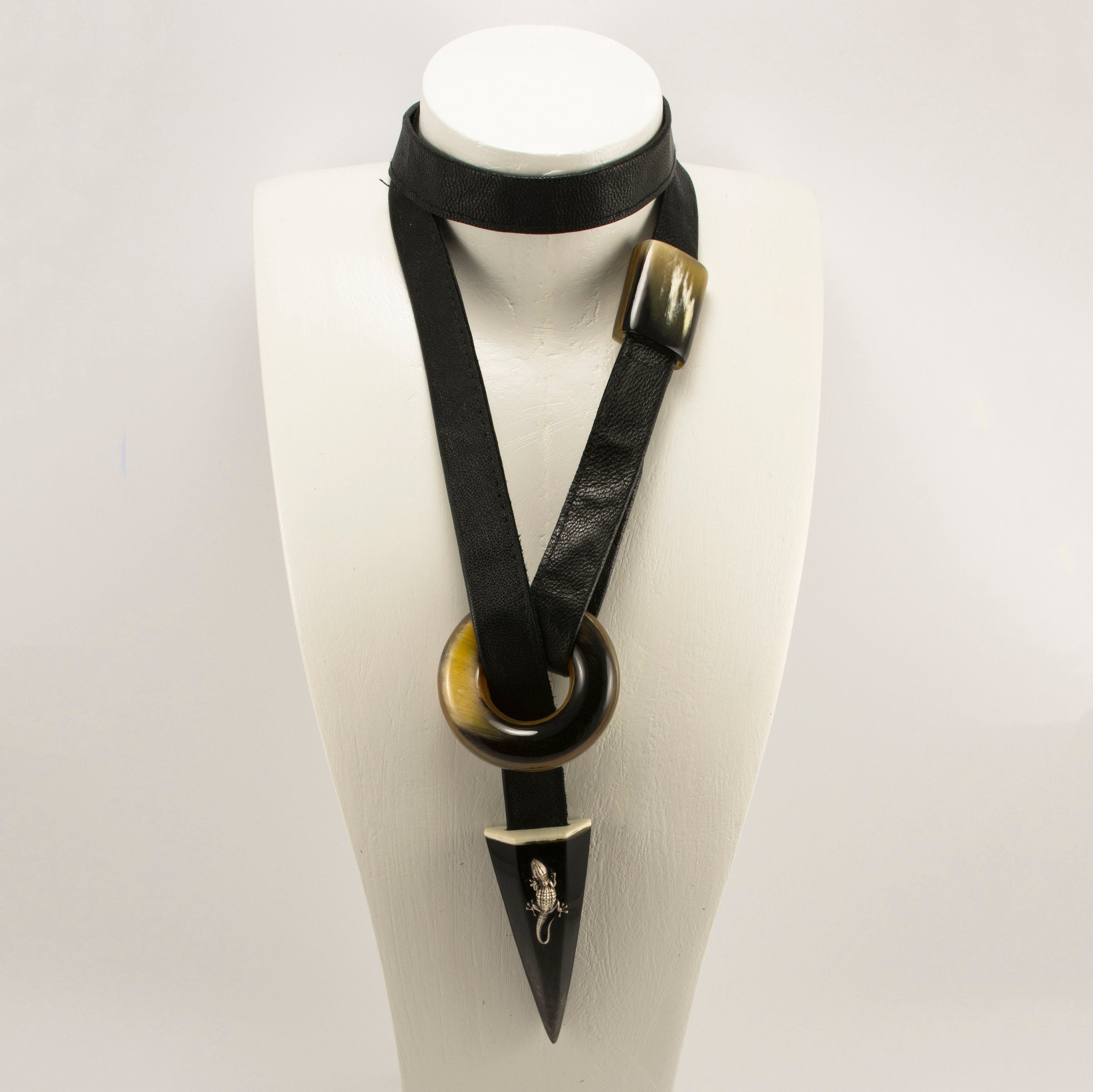 A stunning ethnic necklace for women made from natural horn, featuring a leather cord and a silver salamander clasp, showcasing unique textures and colors.