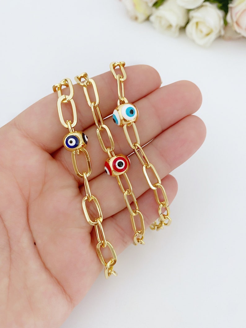 Gold Evil Eye Ankle Bracelet featuring a blue and red charm, perfect for summer jewelry.