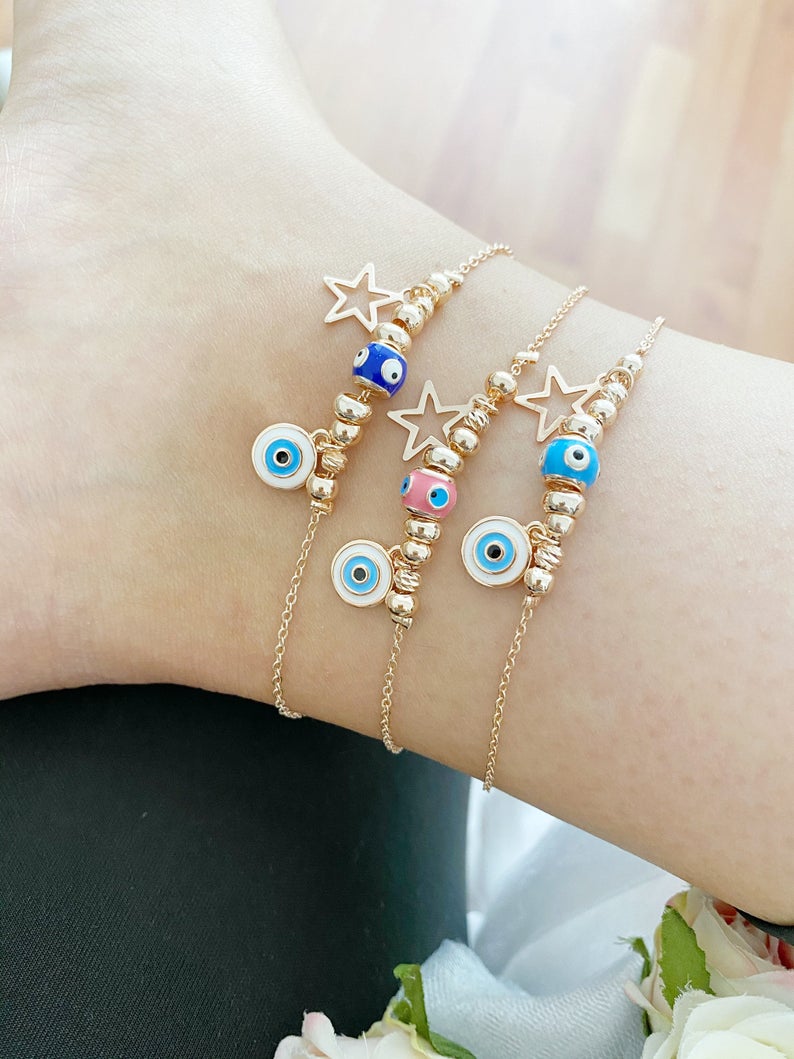 Rose gold evil eye anklet featuring a protective charm and star, perfect for beachwear.