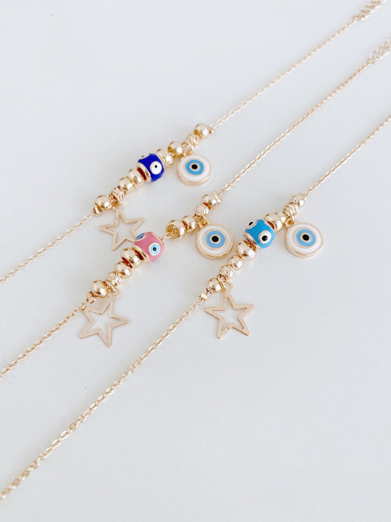 Rose gold evil eye anklet featuring a protective charm and star, perfect for beachwear.