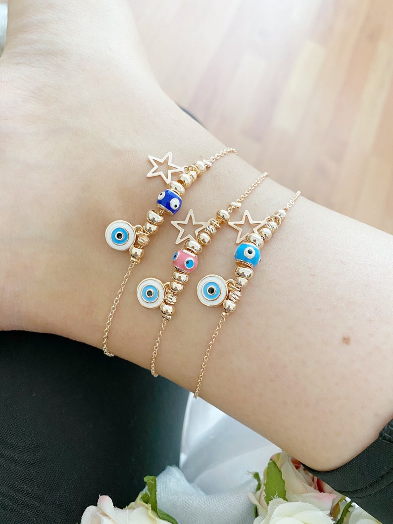 Rose gold evil eye anklet featuring a protective charm and star, perfect for beachwear.