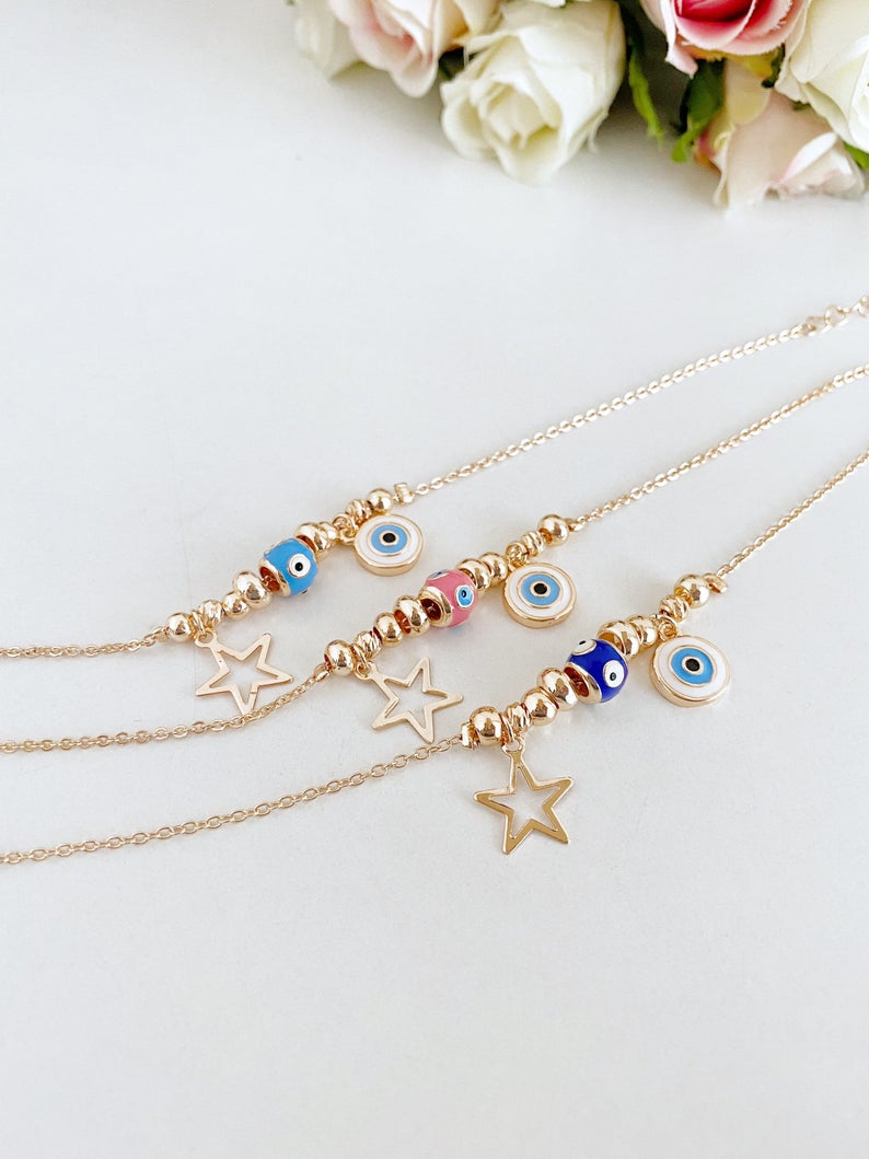 Rose gold evil eye anklet featuring a protective charm and star, perfect for beachwear.