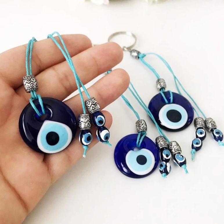 Handmade glass evil eye bag charm, featuring a vibrant blue eye design, measuring 4cm, attached to a 13cm keychain.