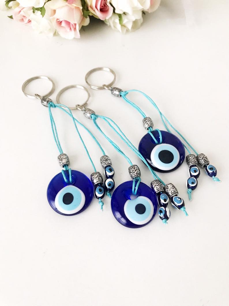 Handmade glass evil eye bag charm, featuring a vibrant blue eye design, measuring 4cm, attached to a 13cm keychain.