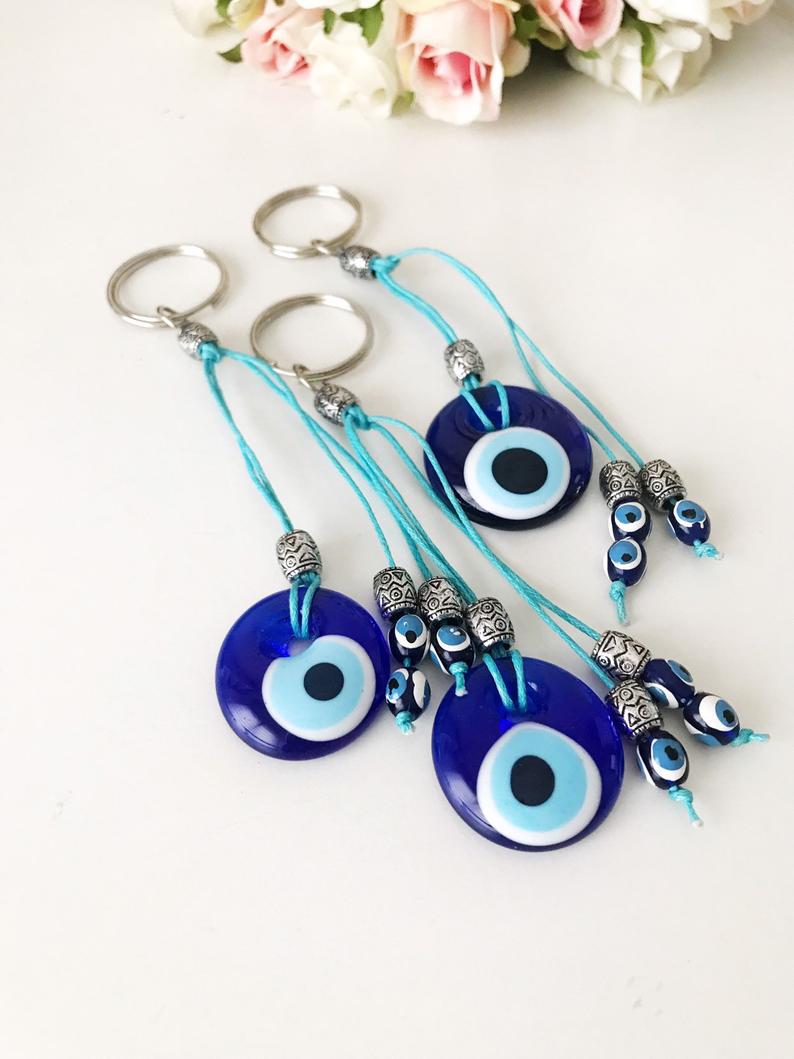 Handmade glass evil eye bag charm, featuring a vibrant blue eye design, measuring 4cm, attached to a 13cm keychain.