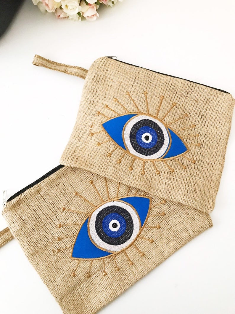 Handmade evil eye bag made from high-quality jute, featuring a blue evil eye design, perfect for beach outings and special occasions.