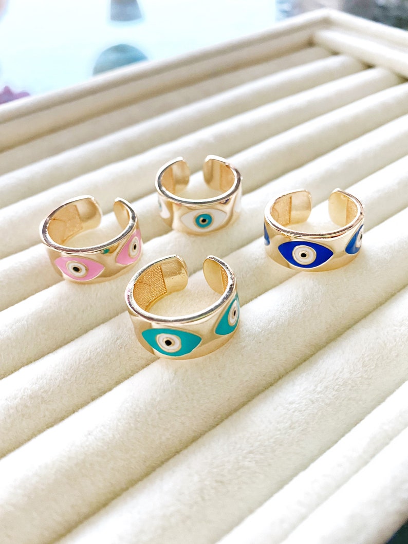 Gold wide adjustable Evil Eye Band Ring featuring colorful eye charms, symbolizing protection and style.