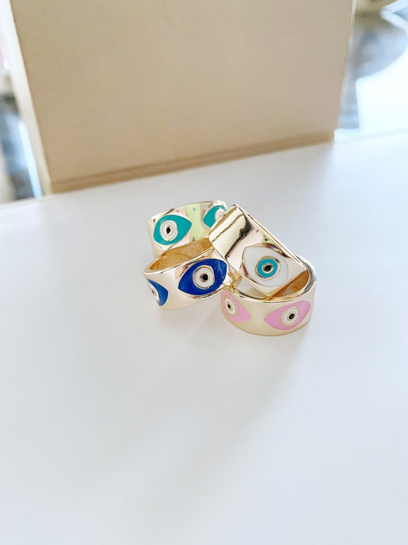 Gold wide adjustable Evil Eye Band Ring featuring colorful eye charms, symbolizing protection and style.