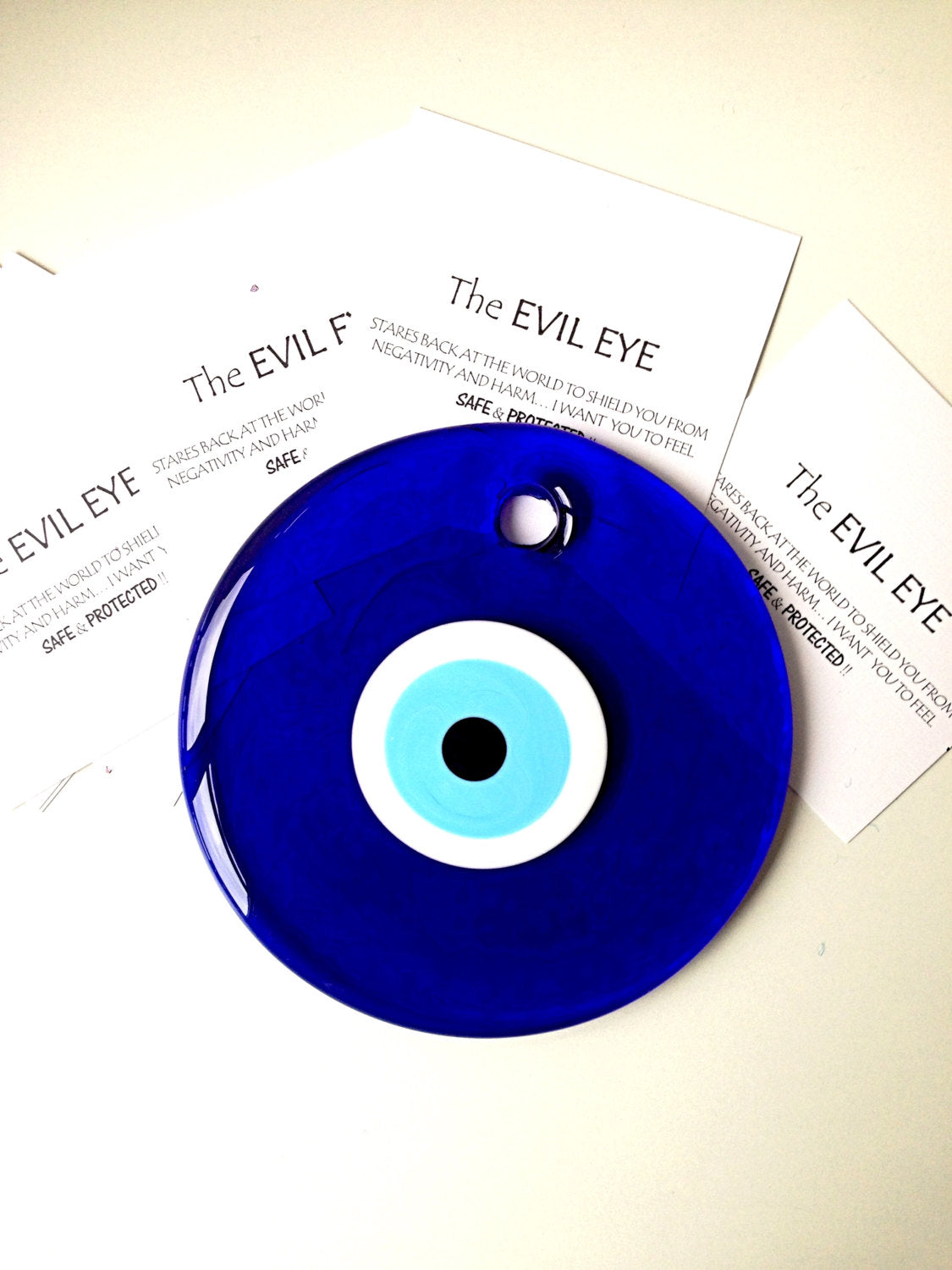 Large 13cm handmade evil eye bead wall hanging with blue rope, symbolizing protection and positivity.