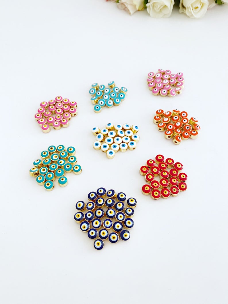 A collection of BULK Evil Eye Beads in various colors, showcasing their 7mm size and intricate designs, perfect for DIY jewelry making.