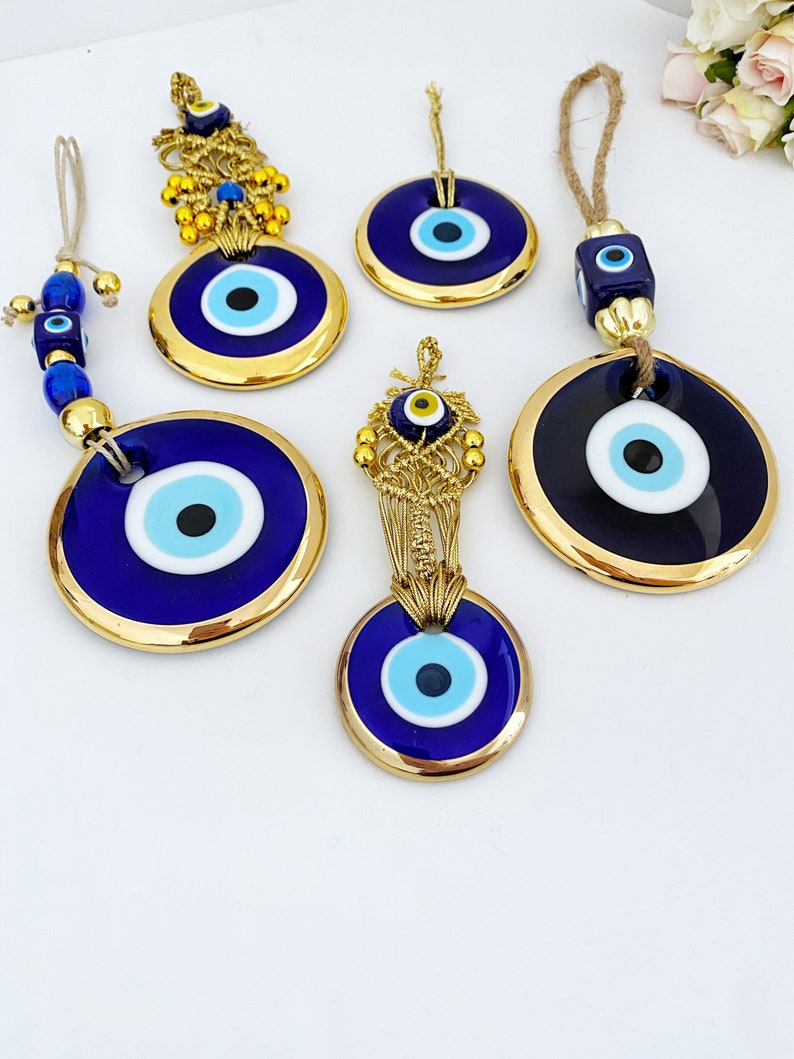 A collection of Gold Evil Eye Beads featuring various styles, showcasing their unique designs and craftsmanship, perfect for Christmas decorations.