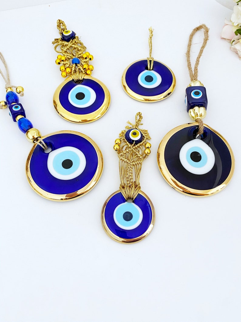 A collection of Gold Evil Eye Beads featuring various styles, showcasing their unique designs and craftsmanship, perfect for Christmas decorations.