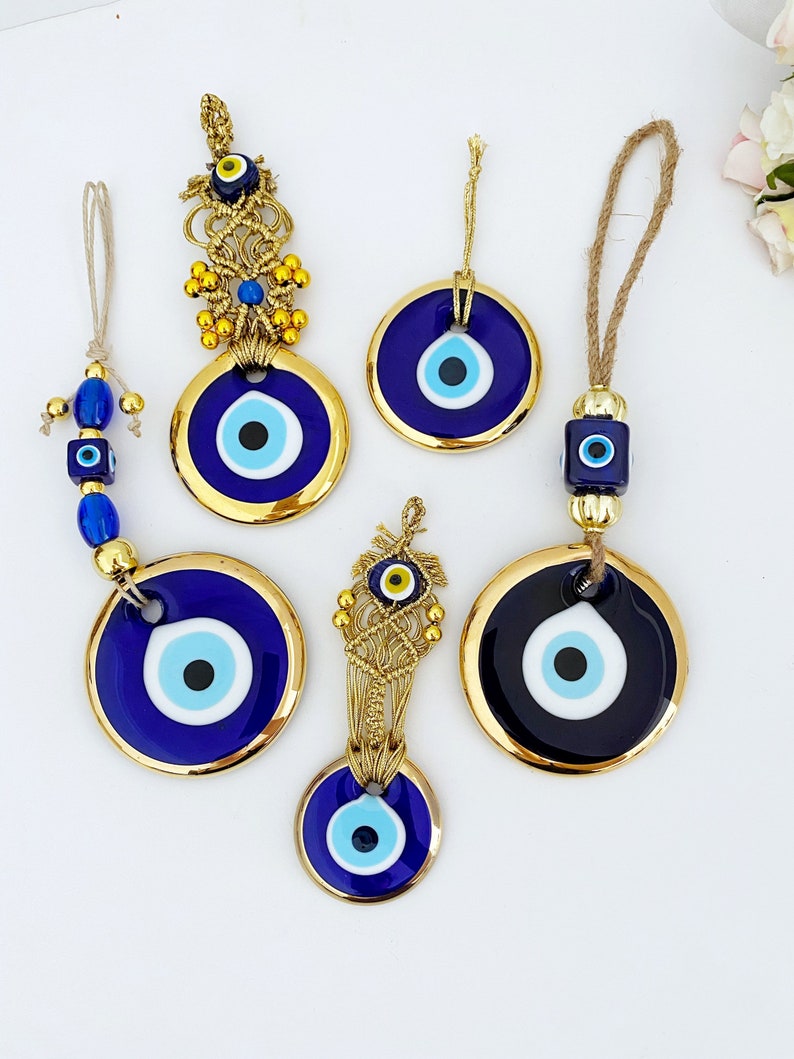 A collection of Gold Evil Eye Beads featuring various styles, showcasing their unique designs and craftsmanship, perfect for Christmas decorations.