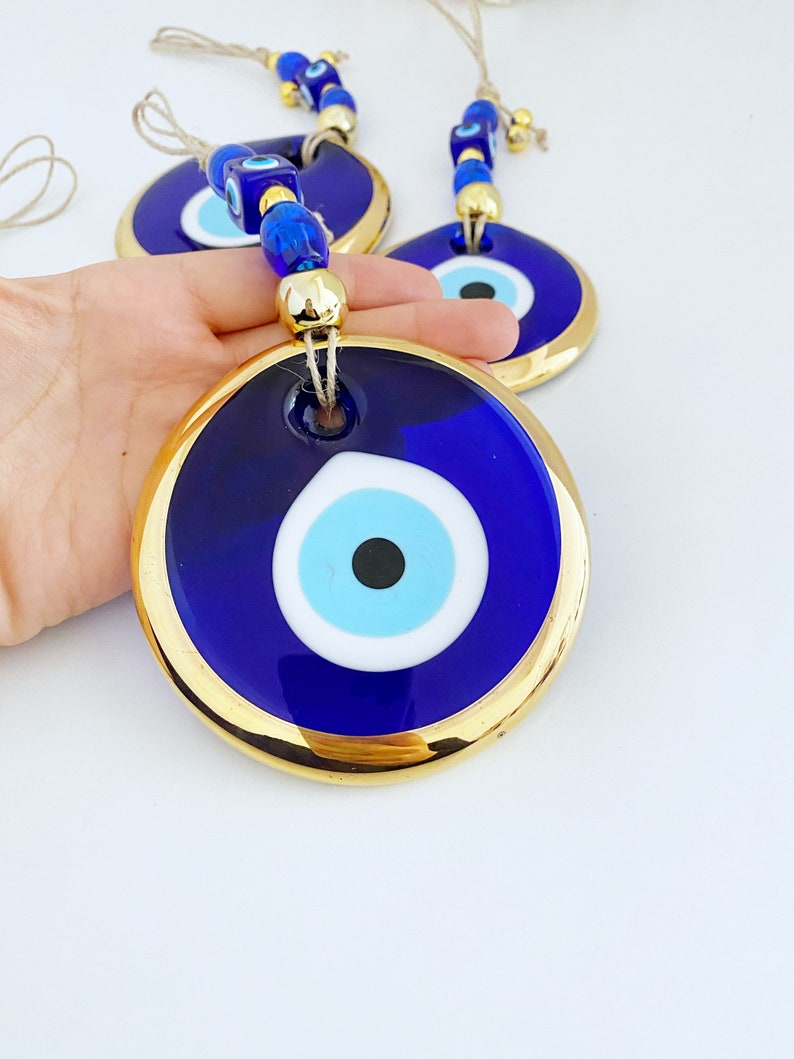 A collection of Gold Evil Eye Beads featuring various styles, showcasing their unique designs and craftsmanship, perfect for Christmas decorations.