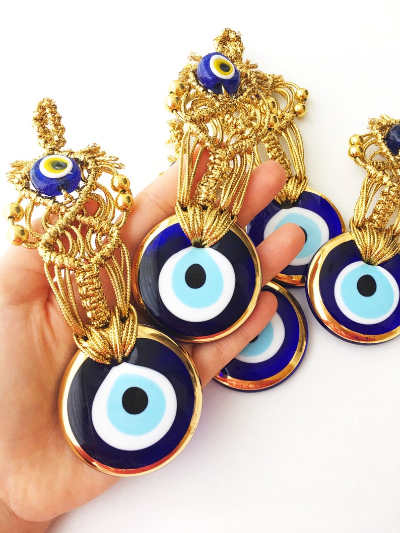 A collection of Gold Evil Eye Beads featuring various styles, showcasing their unique designs and craftsmanship, perfect for Christmas decorations.