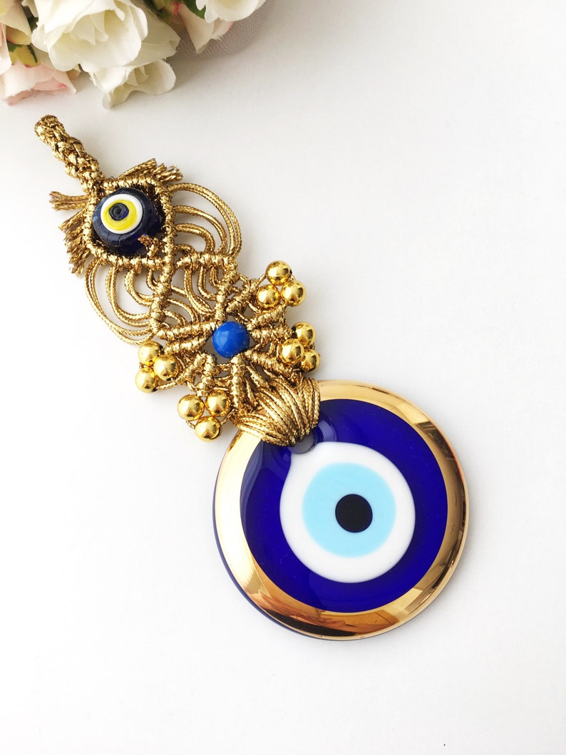 A collection of Gold Evil Eye Beads featuring various styles, showcasing their unique designs and craftsmanship, perfect for Christmas decorations.