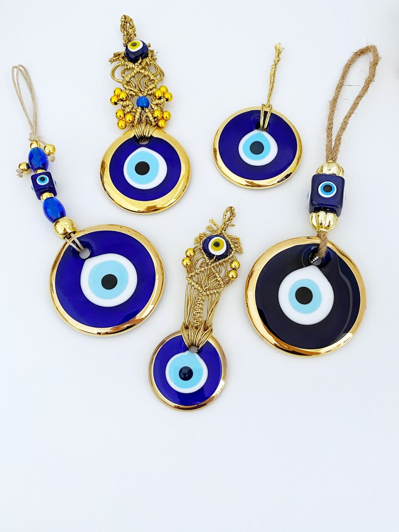 A collection of Gold Evil Eye Beads featuring various styles, showcasing their unique designs and craftsmanship, perfect for Christmas decorations.