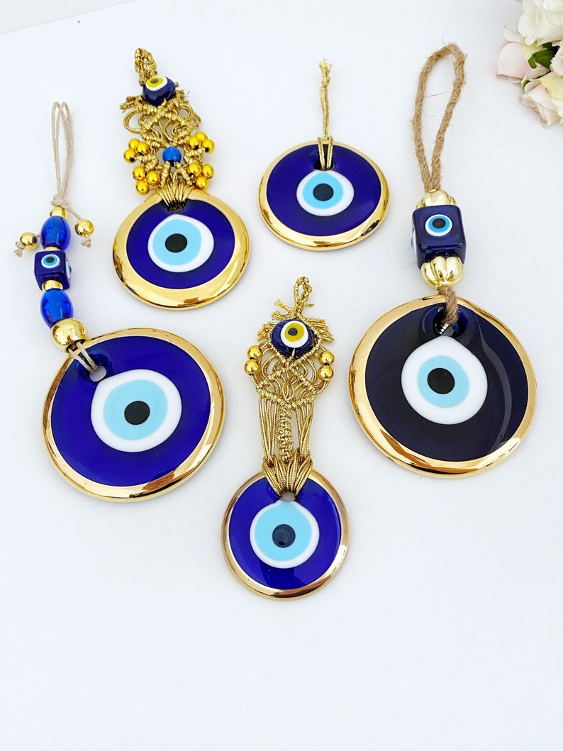 A collection of Gold Evil Eye Beads featuring various styles, showcasing their unique designs and craftsmanship, perfect for Christmas decorations.