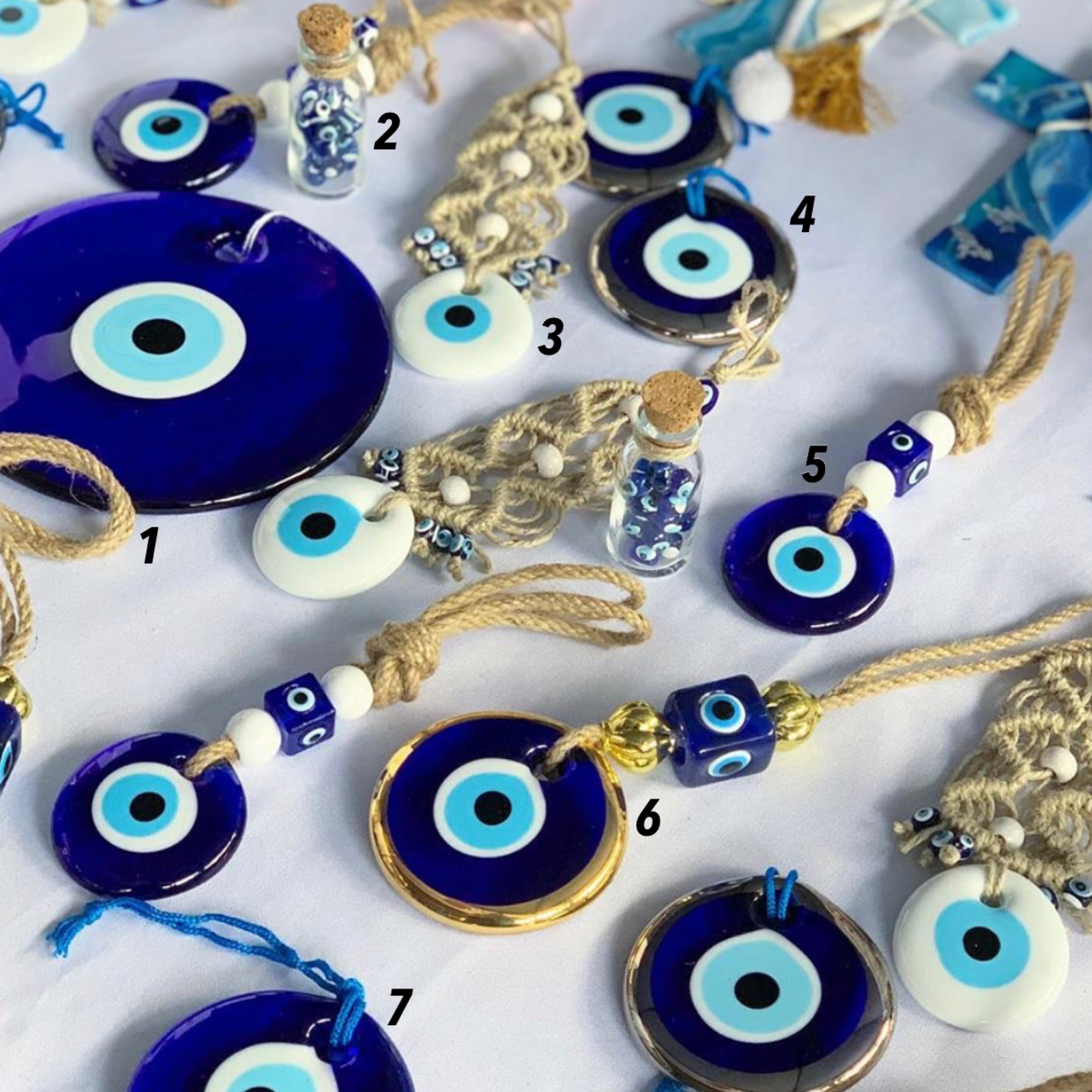 A beautiful collection of handmade evil eye wall hangings featuring various styles and colors, showcasing intricate macrame designs and vibrant beads.