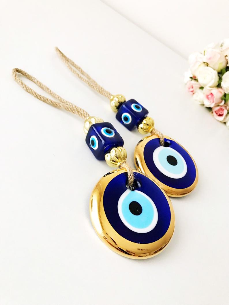 A beautiful collection of handmade evil eye wall hangings featuring various styles and colors, showcasing intricate macrame designs and vibrant beads.