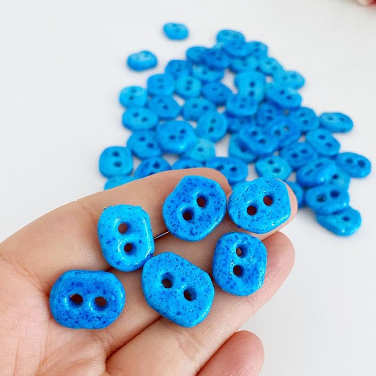 Handmade Evil Eye Beads in turquoise color with two holes, perfect for jewelry making.