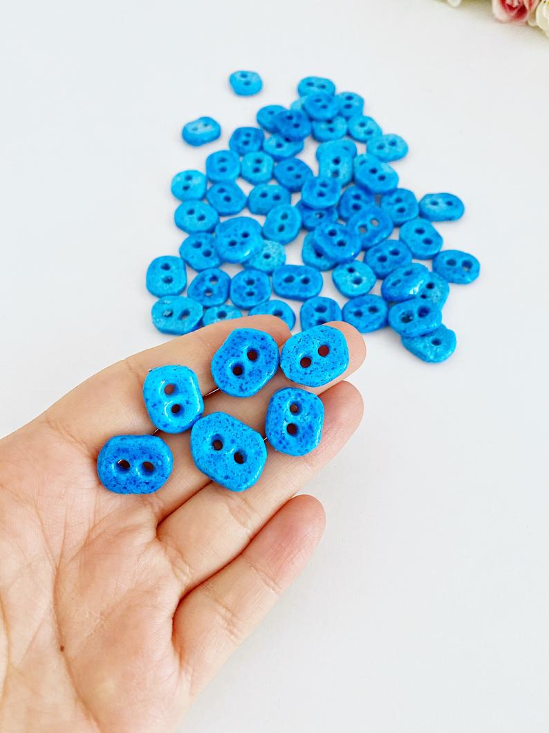 Handmade Evil Eye Beads in turquoise color with two holes, perfect for jewelry making.