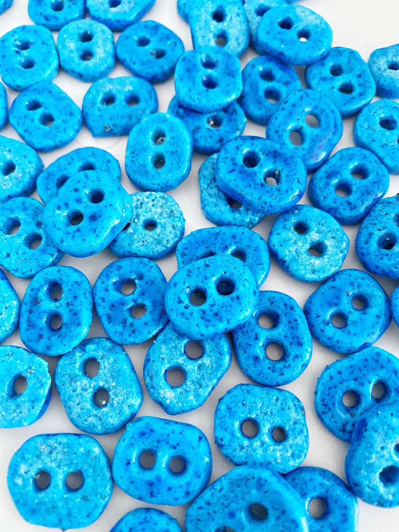 Handmade Evil Eye Beads in turquoise color with two holes, perfect for jewelry making.