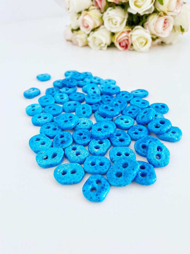 Handmade Evil Eye Beads in turquoise color with two holes, perfect for jewelry making.